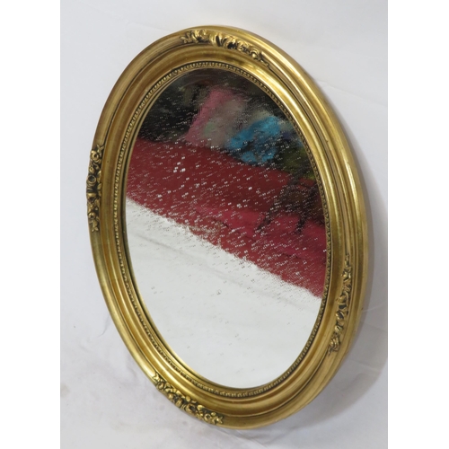 17 - Regency design oval wall mirror with ornate foliate decoration 60x50cm