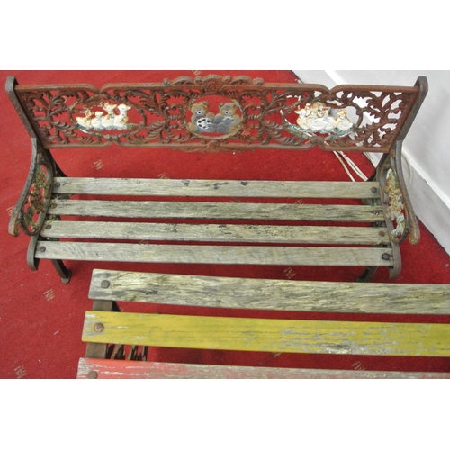 181 - Child's cast iron garden bench and lacquered table with ornate and teddy bear decoration