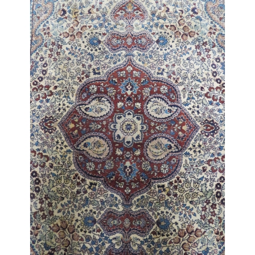 43 - Ivory ground Persian style hearth rug with foliate decoration 220x138cm