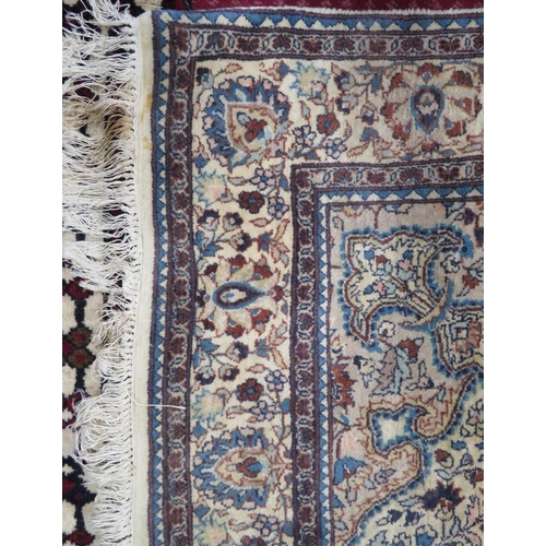 43 - Ivory ground Persian style hearth rug with foliate decoration 220x138cm