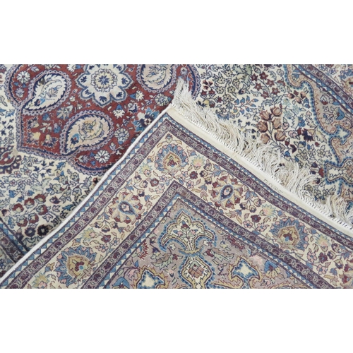 43 - Ivory ground Persian style hearth rug with foliate decoration 220x138cm