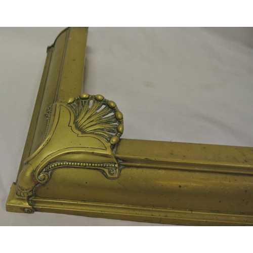 92 - Edwardian brass fire fender with pierced shell decoration