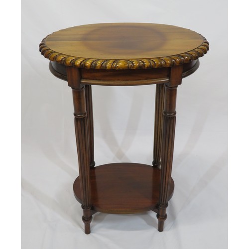 11 - Victorian style oval two tier occasional table with carved borders, and turned columns