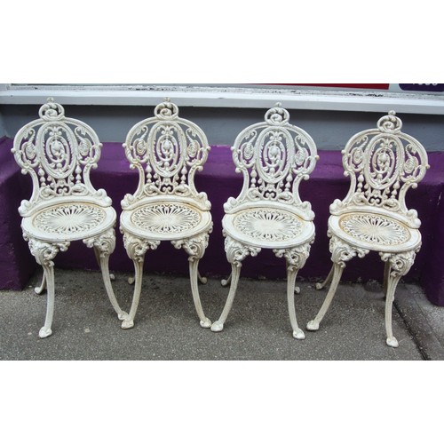 140 - Ornate five piece cast iron garden or patio suite - four chairs and one round table with ornate foli... 