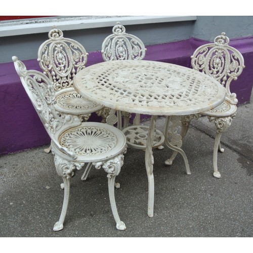 140 - Ornate five piece cast iron garden or patio suite - four chairs and one round table with ornate foli... 