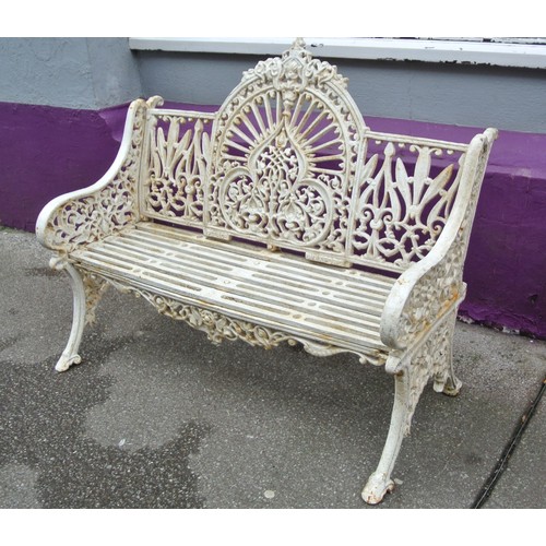 272 - Victorian style cast iron garden seat with domed back, foliate and scroll decoration, shaped legs, s... 