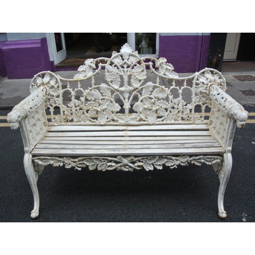 273 - Coalbrookdale style cast iron garden bench with ornate leaf decoration, doghead arms, on shaped legs