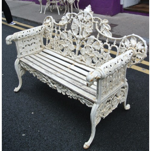 273 - Coalbrookdale style cast iron garden bench with ornate leaf decoration, doghead arms, on shaped legs