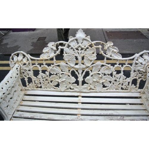 273 - Coalbrookdale style cast iron garden bench with ornate leaf decoration, doghead arms, on shaped legs