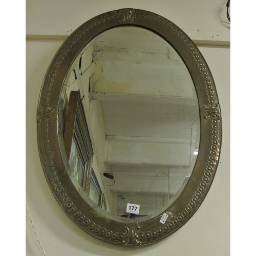 177 - Victorian style oval bevelled glass wall mirror in decorated brass frame