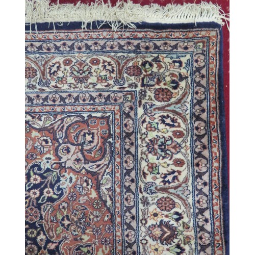 51 - Red ground Persian rug with foliate decoration 230x138cm