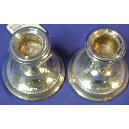 107 - Pair of Birmingham silver round dwarf candlesticks with round bases. H 7cm