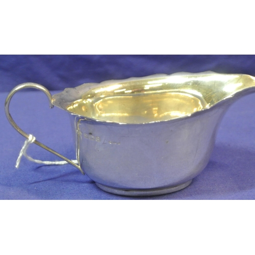 122 - Pair of small Birmingham silver oval sauceboats with wavy rims, shaped handles, on round bases.
 H5c... 