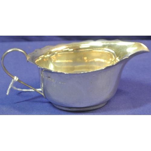 122 - Pair of small Birmingham silver oval sauceboats with wavy rims, shaped handles, on round bases.
 H5c... 