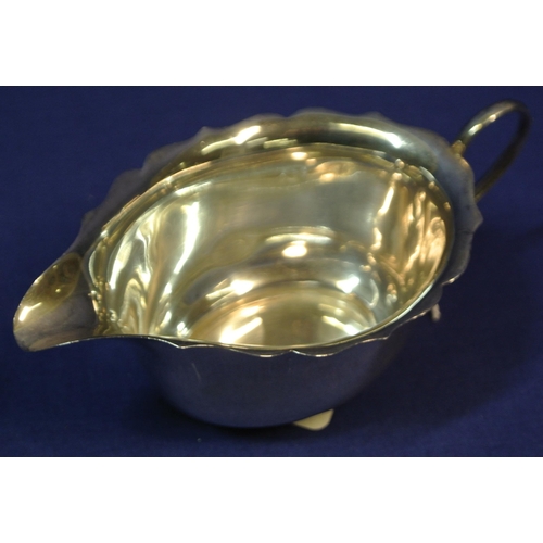 122 - Pair of small Birmingham silver oval sauceboats with wavy rims, shaped handles, on round bases.
 H5c... 