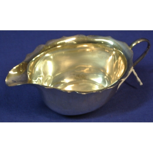 122 - Pair of small Birmingham silver oval sauceboats with wavy rims, shaped handles, on round bases.
 H5c... 