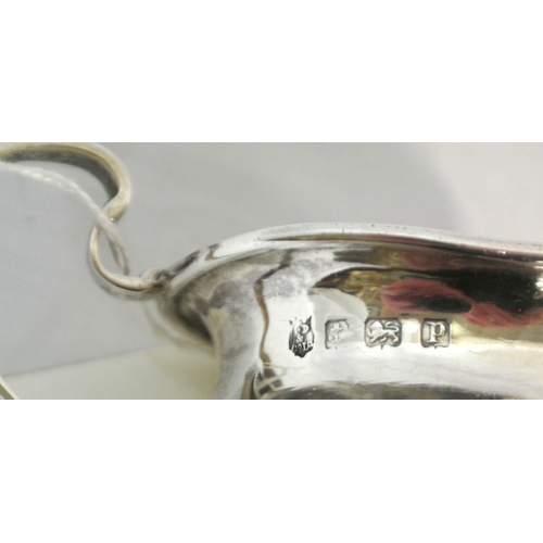 180 - Edward VII Birmingham silver milk jug of oval form with scroll handle, on 4 cast legs with pad feet,... 