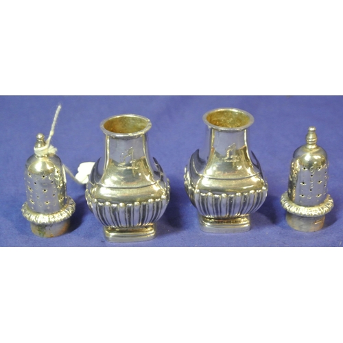 187 - Pair of London silver pepperettes with reeded decoration and stepped bases 98g 10.8cm H