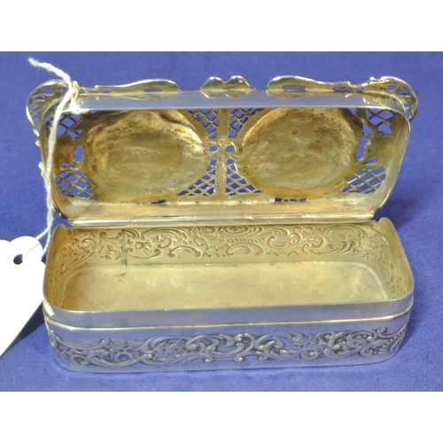 192 - Ornate London silver ring box with cherub decorated pierced top and scroll decoration. H3cm x 11x 5c... 