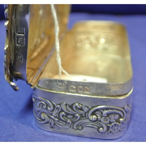 192 - Ornate London silver ring box with cherub decorated pierced top and scroll decoration. H3cm x 11x 5c... 