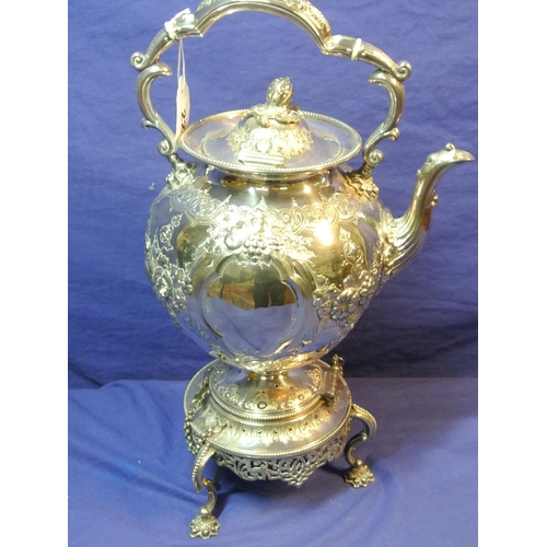 22 - Ornate silver plated kettle on stand decorated and chased with fruit and foliage, hinged, on round b... 