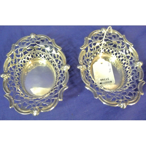 296 - Pair of Cork silver bon bon dishes of serpentine oval shape with ornate foliate lattice and scroll d... 