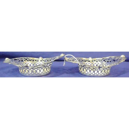 296 - Pair of Cork silver bon bon dishes of serpentine oval shape with ornate foliate lattice and scroll d... 