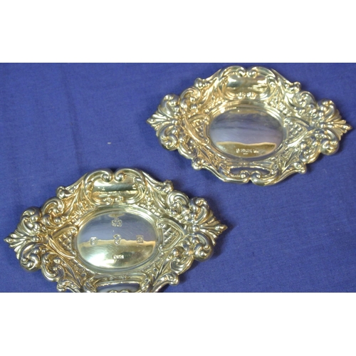 296 - Pair of Cork silver bon bon dishes of serpentine oval shape with ornate foliate lattice and scroll d... 