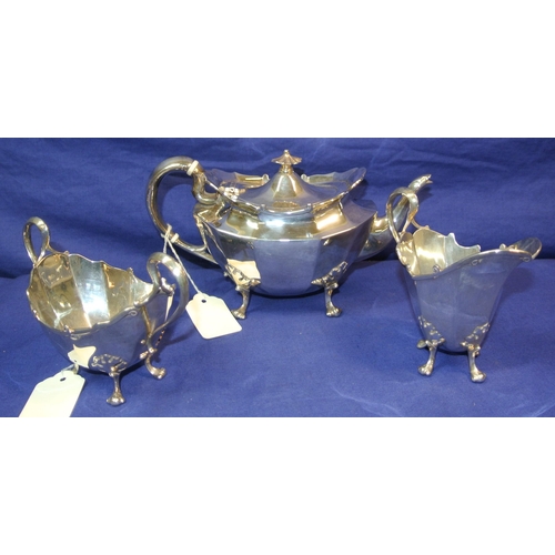 39 - Three piece silverplated tea service of oval panelled form, with shaped handles and cast feet