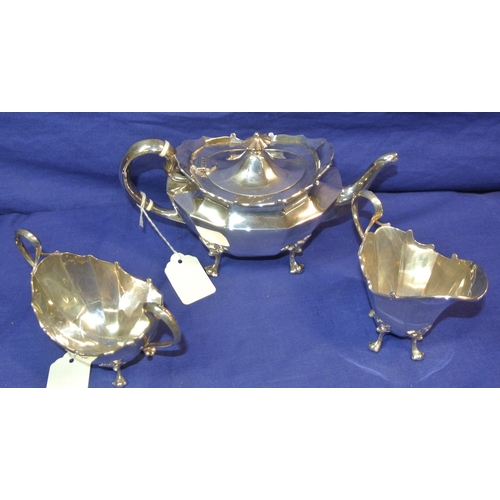 39 - Three piece silverplated tea service of oval panelled form, with shaped handles and cast feet