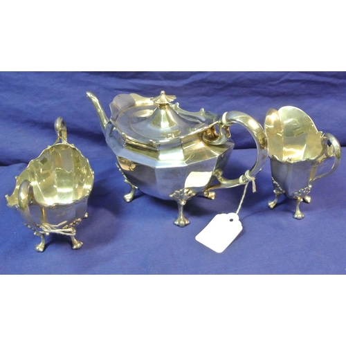 39 - Three piece silverplated tea service of oval panelled form, with shaped handles and cast feet