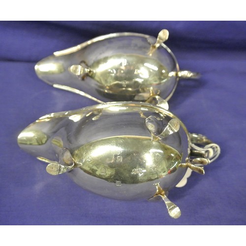 297 - Pair of Irish silver sauceboats by William Egan & Sons Ltd, with Celtic style rims and scroll handle... 