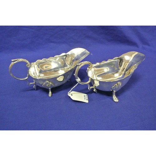 32 - Pair of silverplated sauce or gravy boats with wavy rims, S-shaped handles, and hoof feet