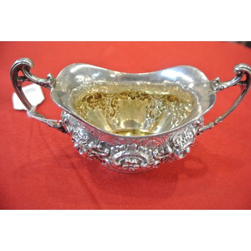 98 - Ornate Sheffield silver oval sugar bowl with wavy rim, ornate scroll and foliate decoration, shaped ... 