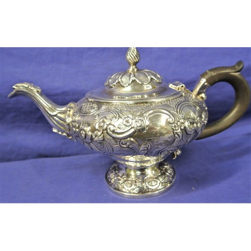 100 - George VI London silver teapot of round squat form, ornately decorated and chased with scrolls and f... 