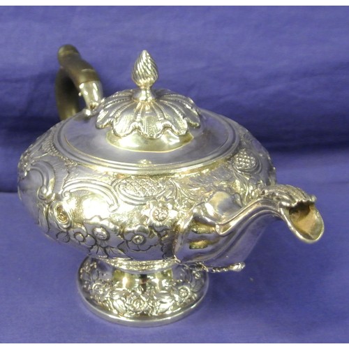 100 - George VI London silver teapot of round squat form, ornately decorated and chased with scrolls and f... 