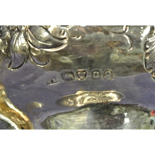 100 - George VI London silver teapot of round squat form, ornately decorated and chased with scrolls and f... 