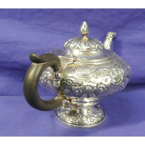 100 - George VI London silver teapot of round squat form, ornately decorated and chased with scrolls and f... 