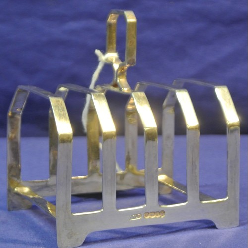 129 - Sheffield silver 4 section toast rack with shaped handle.H 8cm x L8 x 6 cm