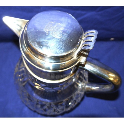 131 - Victorian London silver mounted claret jug, crested lid with thumbpiece, shaped handle and hobnail c... 