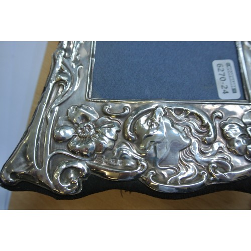 259 - Pair of Irish silver photograph frames with ornate foliate decoration and crested cartouches H 22cm ... 