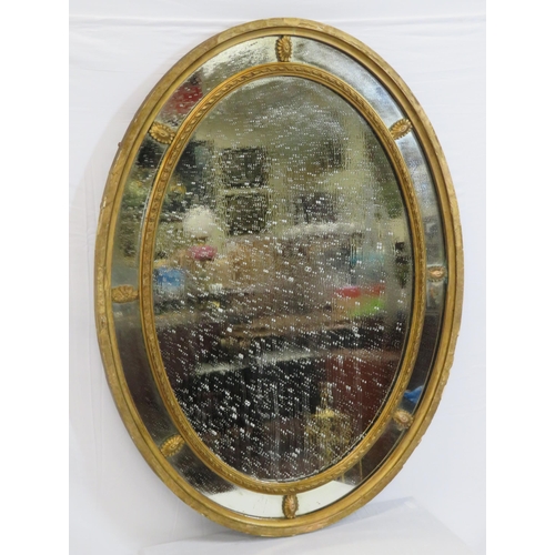 109 - Oval Regency style double framed gilt wall mirror with reeded decoration