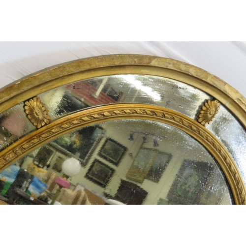 109 - Oval Regency style double framed gilt wall mirror with reeded decoration