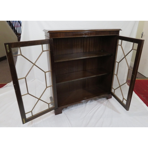 20 - Edwardian mahogany bookcase with glazed doors, reeded shelving, on bracket feet