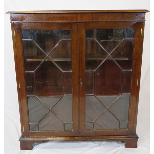 20 - Edwardian mahogany bookcase with glazed doors, reeded shelving, on bracket feet