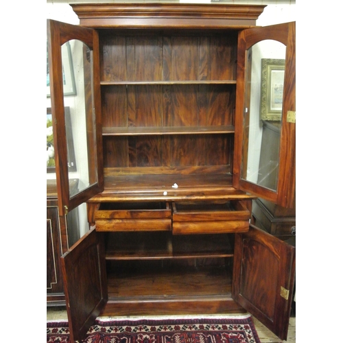 25 - Victorian style bookcase with shaped leaves, glazed doors with shelved interior, shelved press under... 