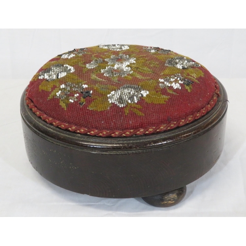 28 - Two round Georgian footstools with foliate needlepoint and turned legs