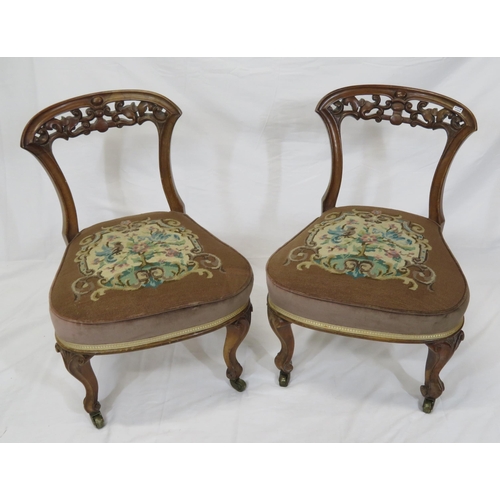 378 - Pair of Victorian low occasional chairs with scroll foliate carved rails, upholstered seat, on cabri... 