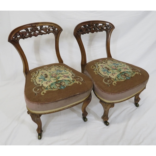 378 - Pair of Victorian low occasional chairs with scroll foliate carved rails, upholstered seat, on cabri... 