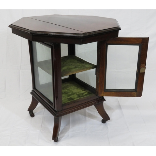 59 - Edwardian mahogany hexagonal table with glazed press under, on shaped legs with castors